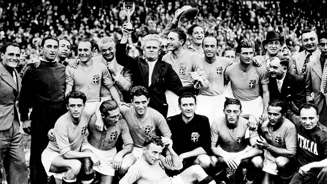 Italy's soccer team coach Vittorio Pozzo, surrounded by his players, holds aloft the Jules Rimet Cup,after Italy won the World Cup Final, in Colombes Stadium, Paris, France, June 19, 1938. Italy defeated Hungary by four goals to two in the final. (AP Photo)